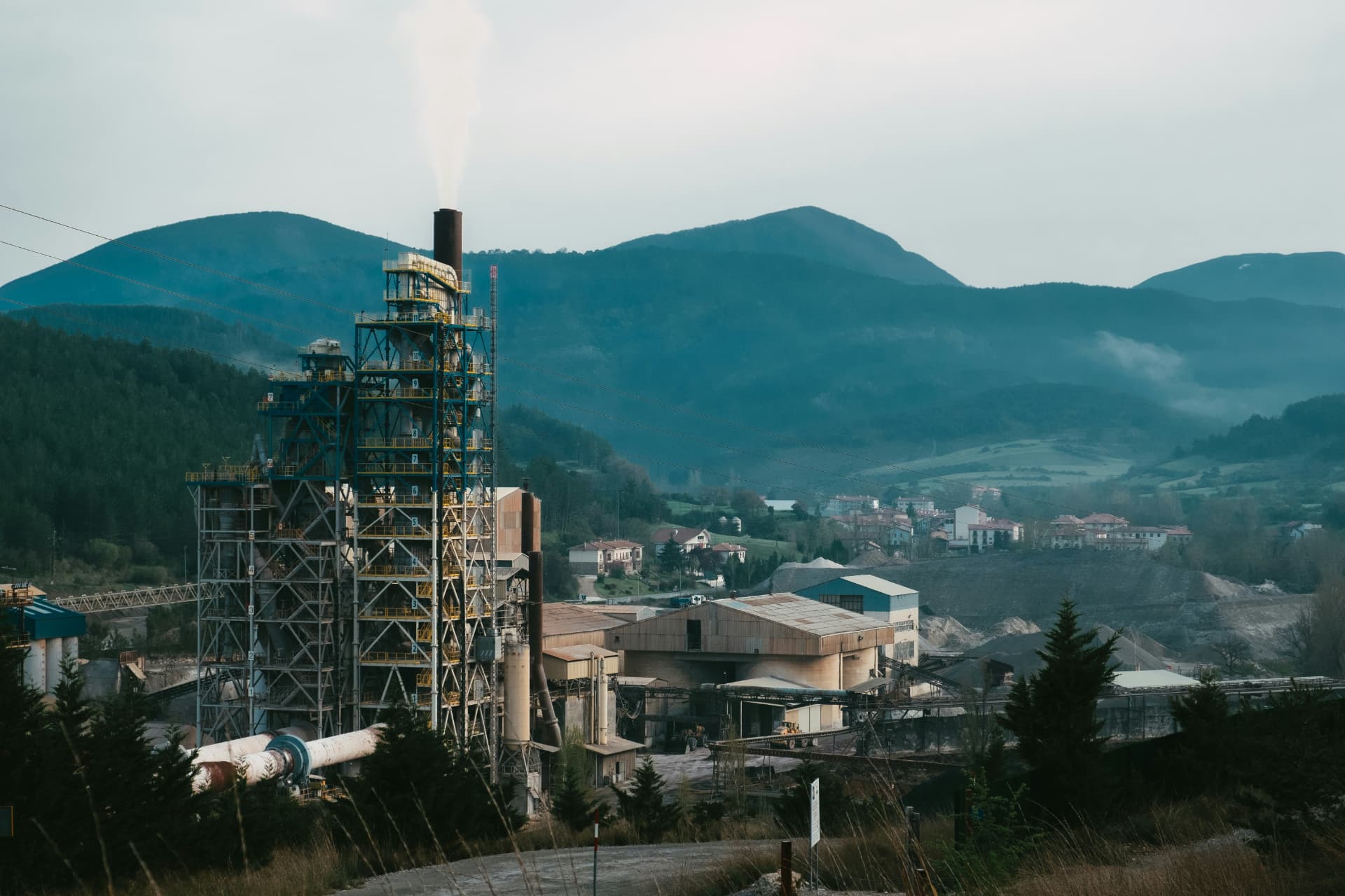 Industrial plant with kiln towers in a forested valley