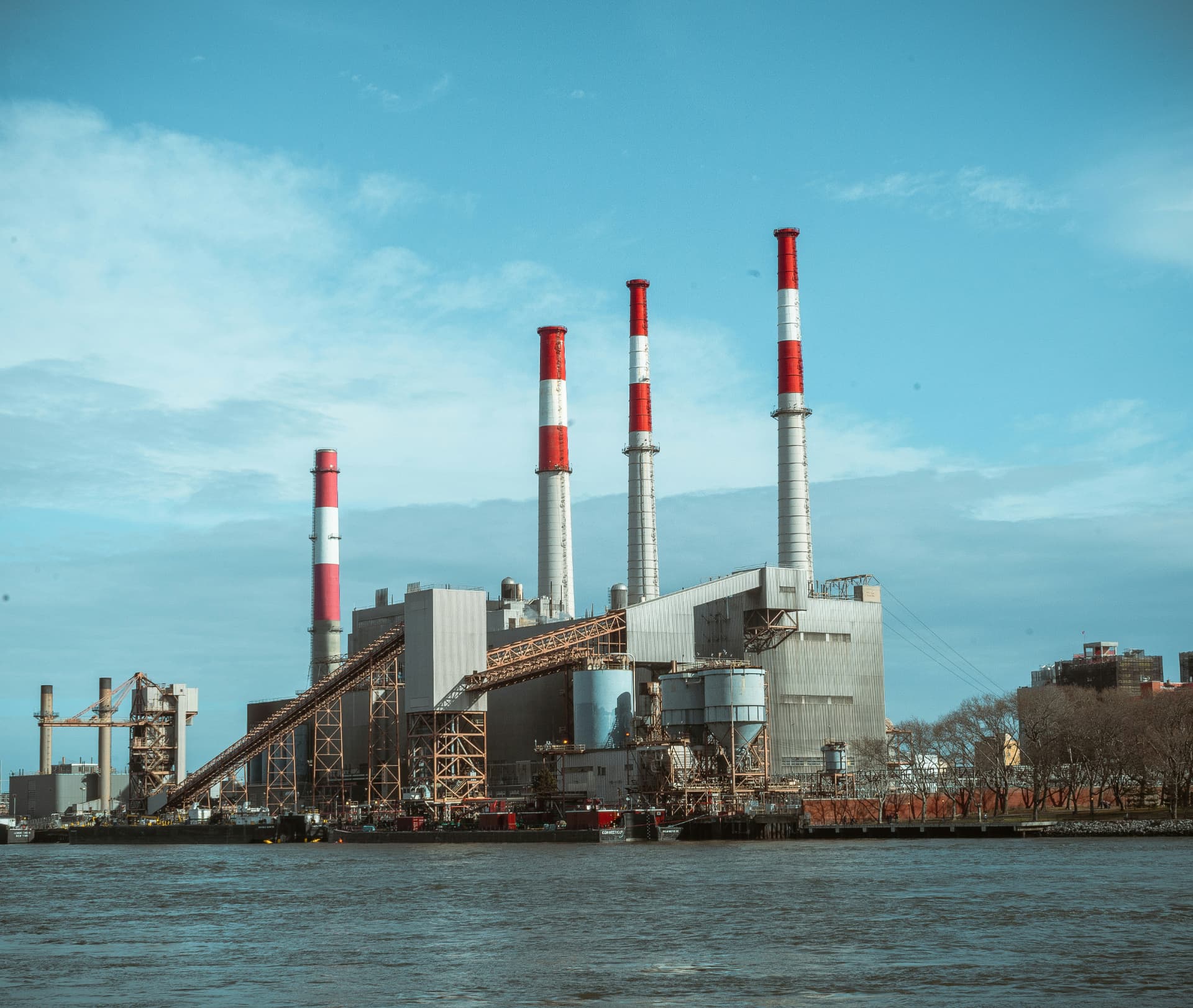 Waterfront waste-to-energy plant with striped stacks