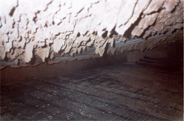 Flue gas passage partially blocked by hardened deposits